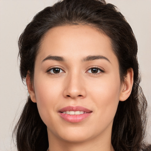 Joyful white young-adult female with long  brown hair and brown eyes