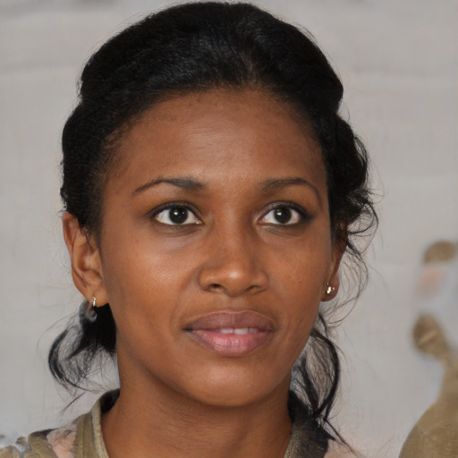 Joyful black young-adult female with medium  brown hair and brown eyes