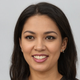 Joyful latino young-adult female with long  brown hair and brown eyes