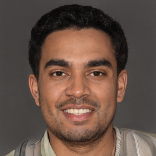 Joyful latino young-adult male with short  black hair and brown eyes