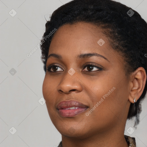 Joyful black young-adult female with short  black hair and brown eyes