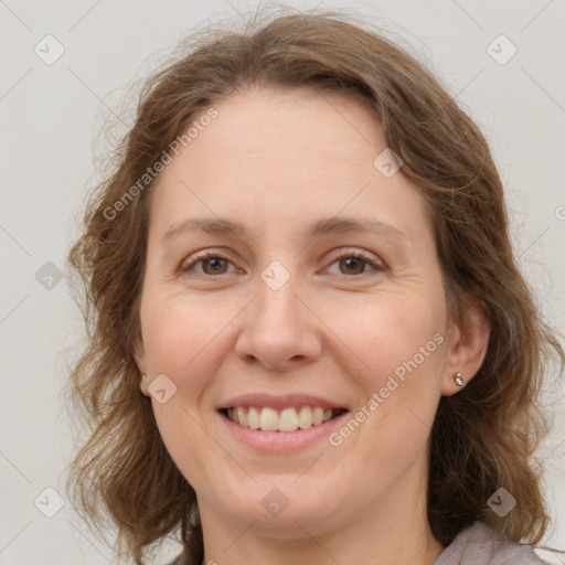 Joyful white adult female with medium  brown hair and grey eyes