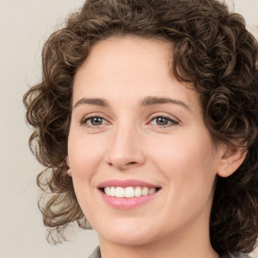 Joyful white young-adult female with medium  brown hair and green eyes