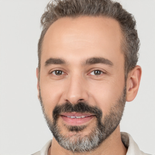 Joyful white adult male with short  black hair and brown eyes