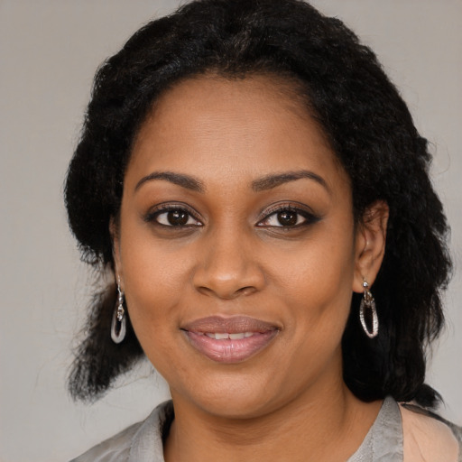 Joyful black young-adult female with medium  black hair and brown eyes