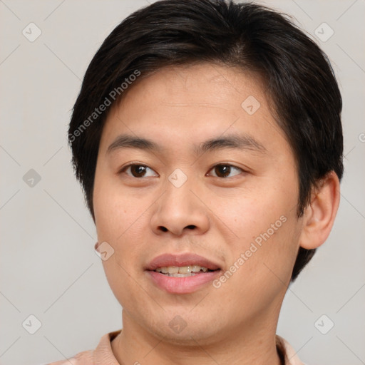 Joyful asian young-adult male with short  brown hair and brown eyes