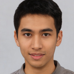 Joyful asian young-adult male with short  brown hair and brown eyes