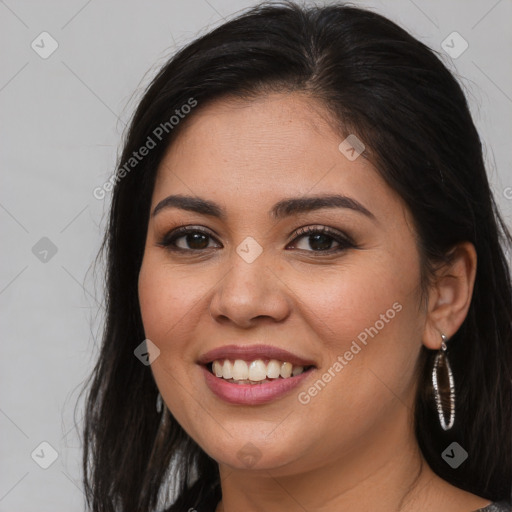 Joyful latino young-adult female with long  brown hair and brown eyes