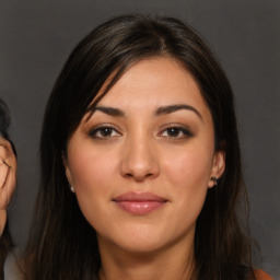 Joyful white young-adult female with long  brown hair and brown eyes