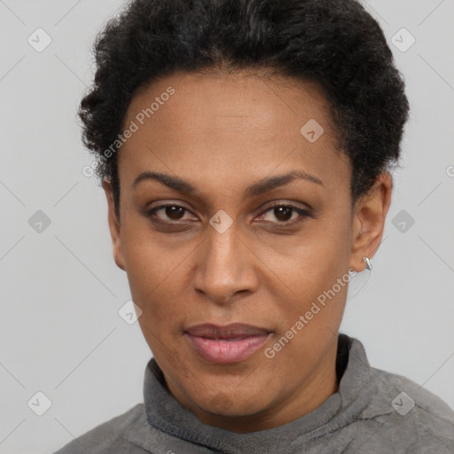 Joyful black adult female with short  black hair and brown eyes