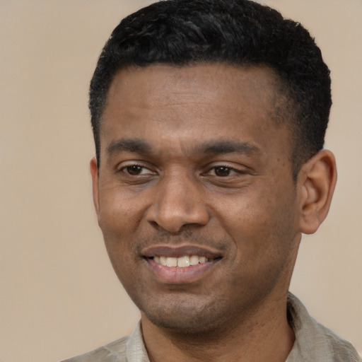 Joyful latino young-adult male with short  black hair and brown eyes