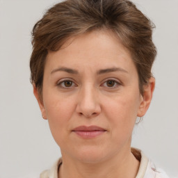 Joyful white adult female with short  brown hair and brown eyes