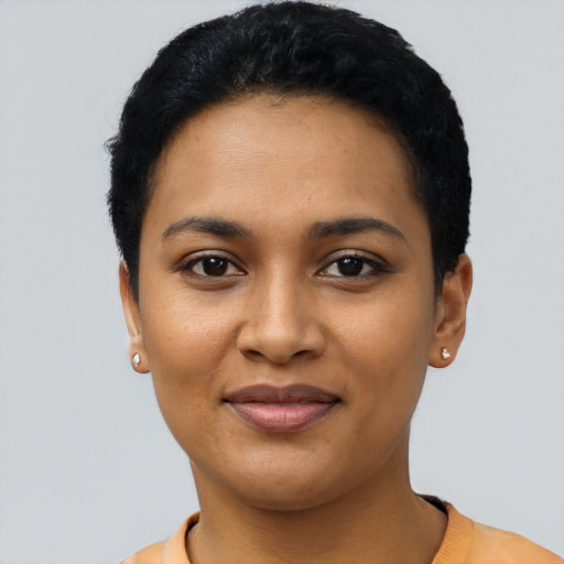 Joyful latino young-adult female with short  black hair and brown eyes