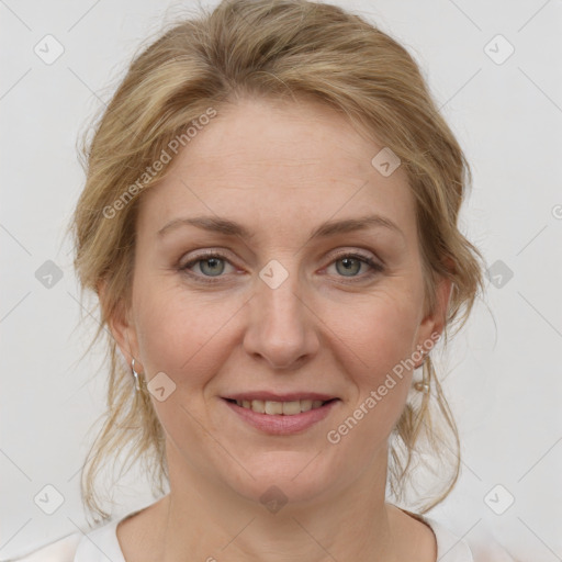 Joyful white adult female with medium  brown hair and blue eyes