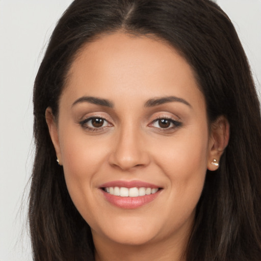 Joyful white young-adult female with long  brown hair and brown eyes