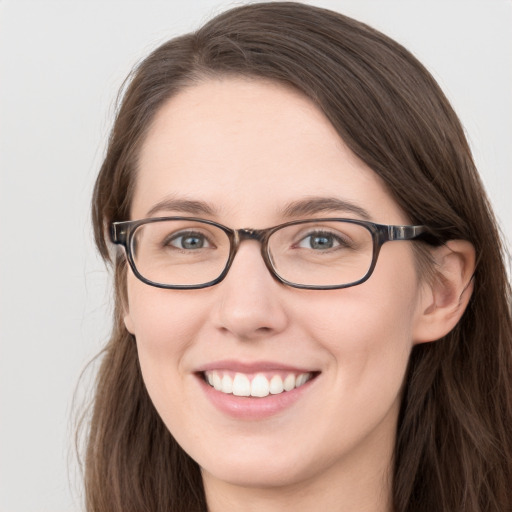 Joyful white young-adult female with long  brown hair and blue eyes