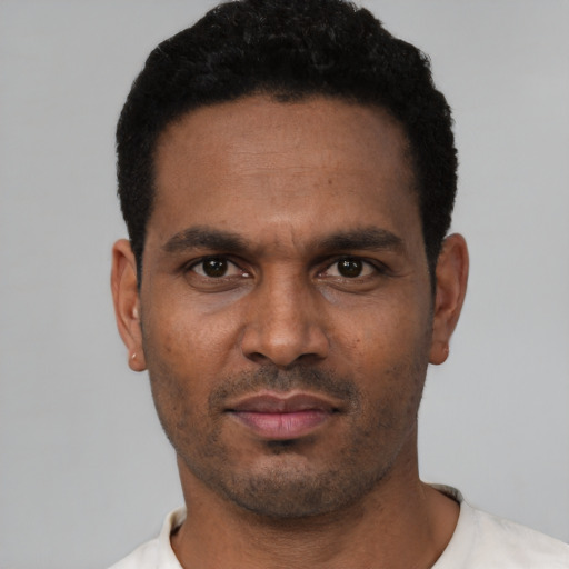 Neutral latino young-adult male with short  black hair and brown eyes