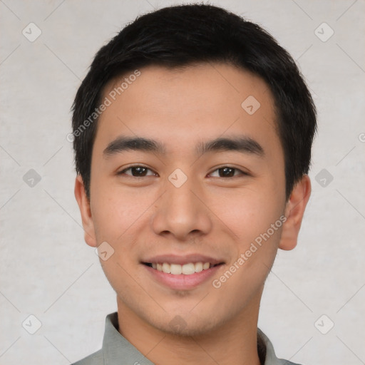 Joyful asian young-adult male with short  black hair and brown eyes