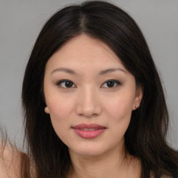 Joyful asian young-adult female with long  brown hair and brown eyes