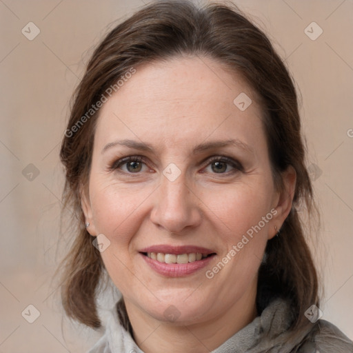 Joyful white adult female with medium  brown hair and grey eyes