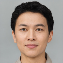 Joyful asian young-adult male with short  black hair and brown eyes