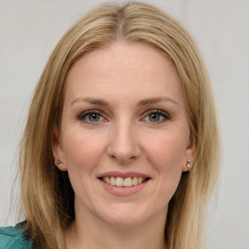 Joyful white adult female with long  brown hair and green eyes