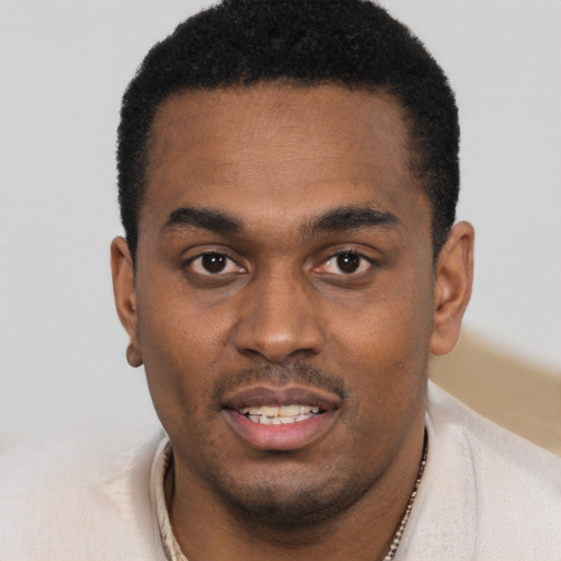 Joyful black young-adult male with short  black hair and brown eyes