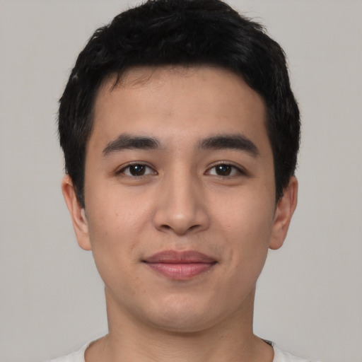 Joyful asian young-adult male with short  black hair and brown eyes