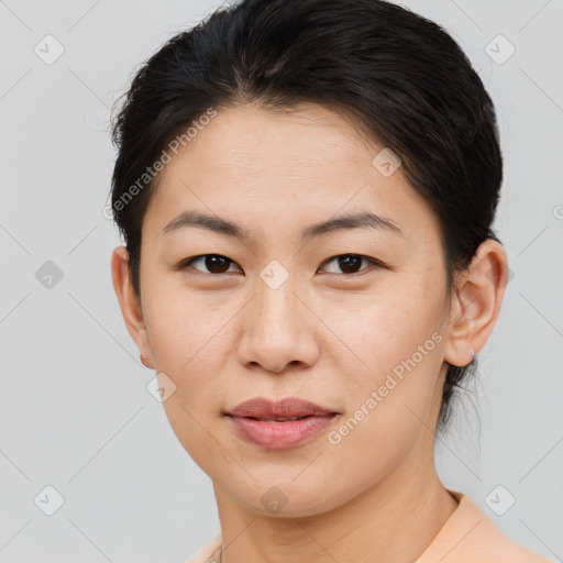 Joyful asian young-adult female with short  brown hair and brown eyes