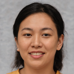 Joyful asian young-adult female with medium  brown hair and brown eyes