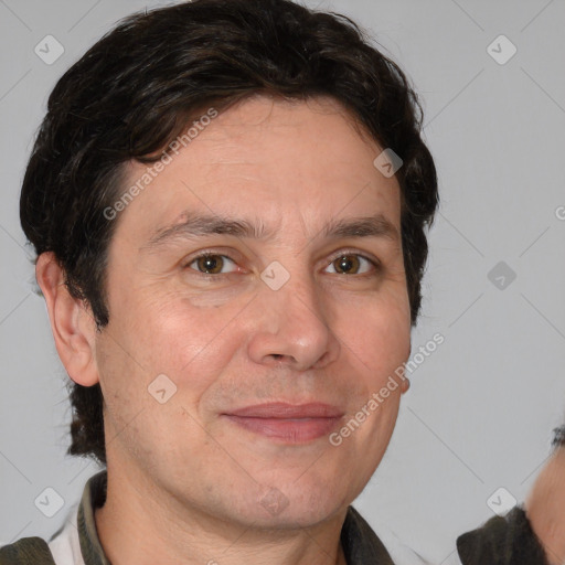 Joyful white adult male with medium  brown hair and brown eyes