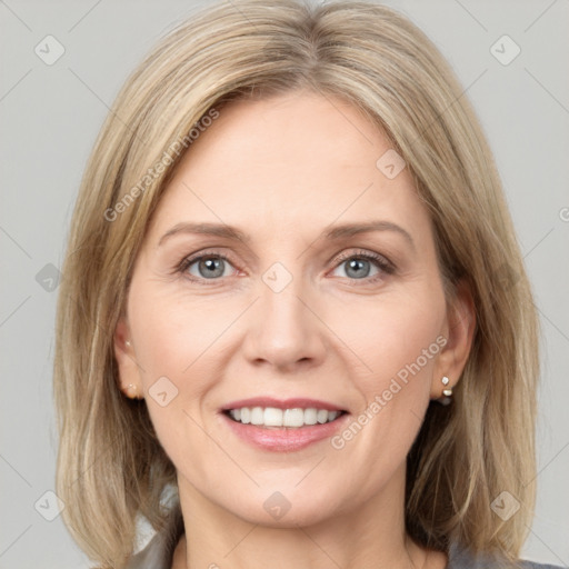 Joyful white young-adult female with medium  brown hair and grey eyes