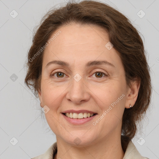 Joyful white adult female with medium  brown hair and grey eyes