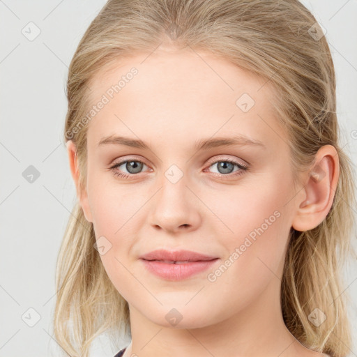 Joyful white young-adult female with long  brown hair and blue eyes