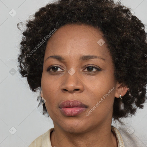 Joyful black adult female with medium  brown hair and brown eyes