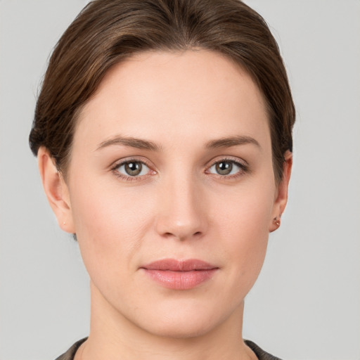 Joyful white young-adult female with short  brown hair and grey eyes