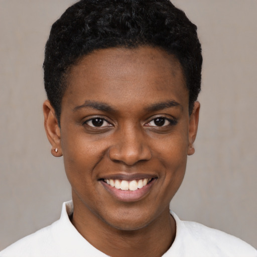 Joyful black young-adult female with short  black hair and brown eyes
