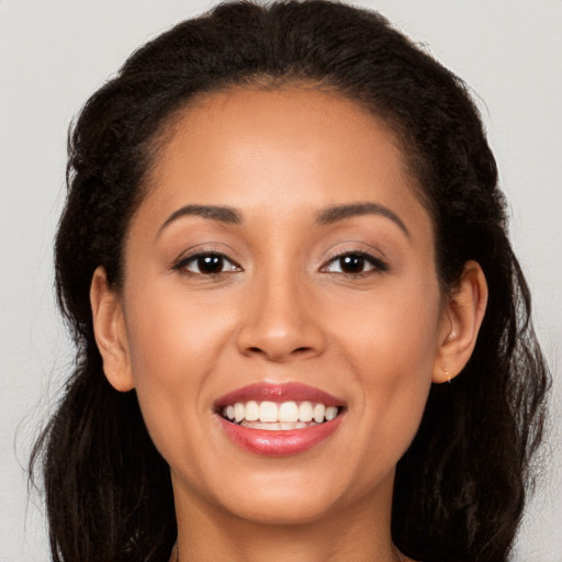 Joyful white young-adult female with long  brown hair and brown eyes