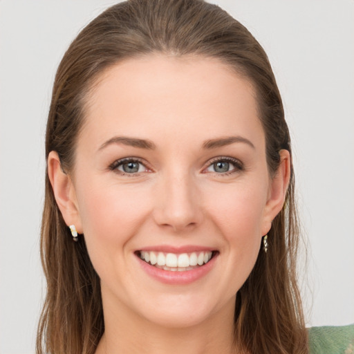 Joyful white young-adult female with long  brown hair and grey eyes