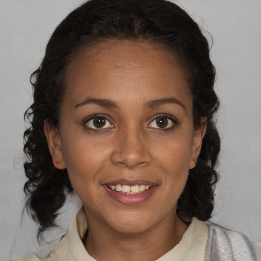 Joyful black young-adult female with medium  brown hair and brown eyes