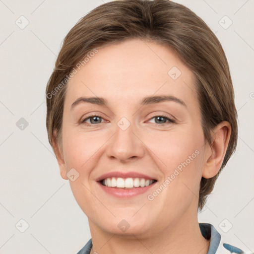 Joyful white young-adult female with short  brown hair and grey eyes