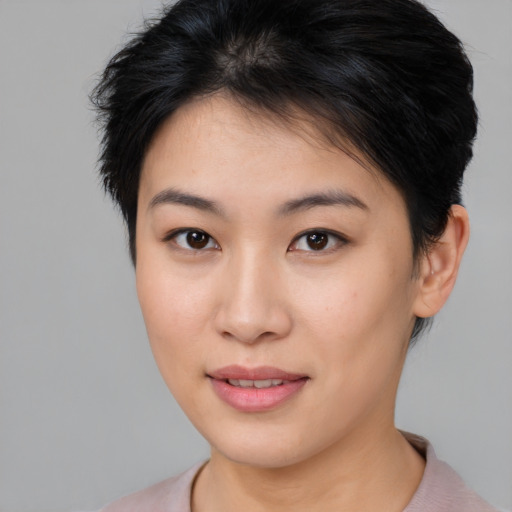 Joyful asian young-adult female with short  brown hair and brown eyes