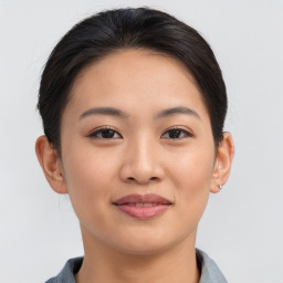 Joyful asian young-adult female with short  brown hair and brown eyes