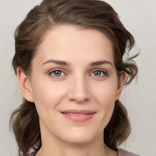 Joyful white young-adult female with medium  brown hair and grey eyes