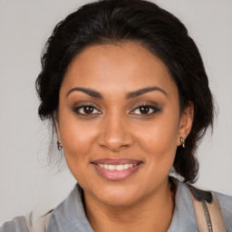 Joyful black young-adult female with medium  brown hair and brown eyes