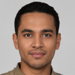 Joyful latino young-adult male with short  brown hair and brown eyes