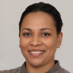 Joyful white adult female with short  brown hair and brown eyes