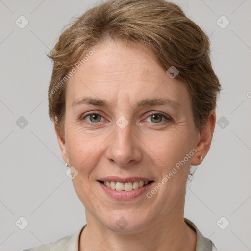 Joyful white adult female with short  brown hair and grey eyes