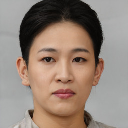 Joyful asian young-adult female with short  black hair and brown eyes