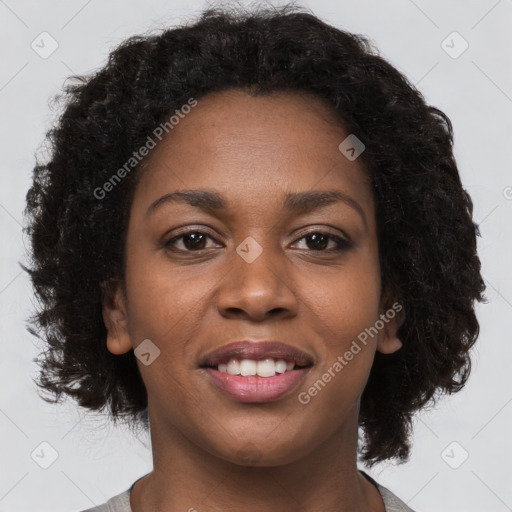 Joyful black young-adult female with long  brown hair and brown eyes